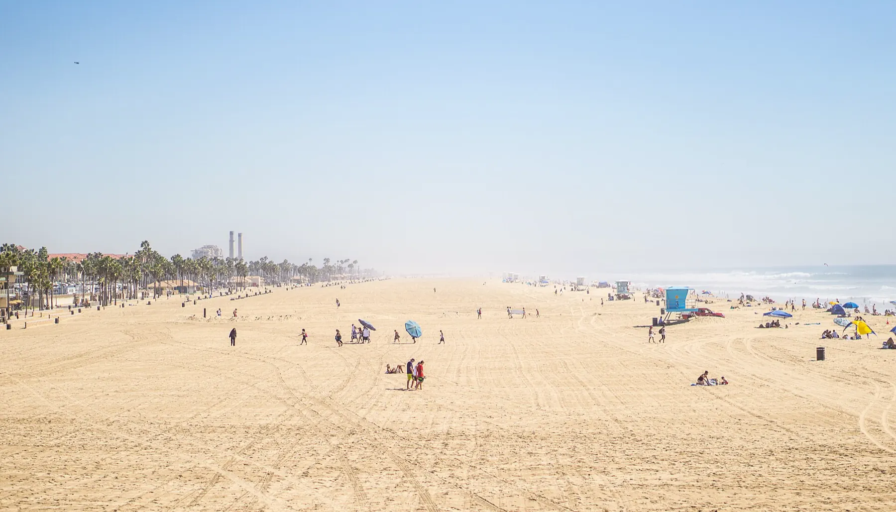 An open seashore on a hot afternoon, the water Sol & Salt cuts for